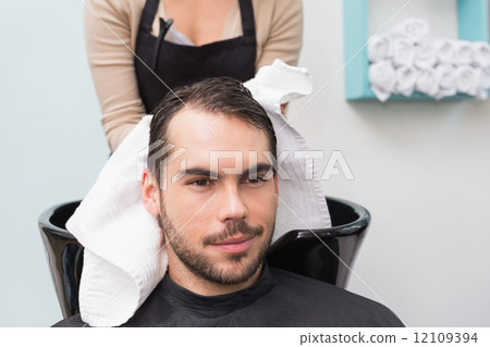 Hair stylist drying mans hair Hair stylist drying mans hair 12109394
