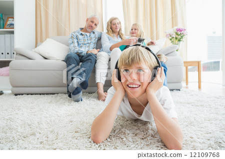 Little boy listening to music on the floor Little boy listening to music on the floor 12109768