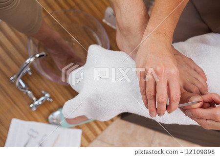Customer getting a pedicure 12109898