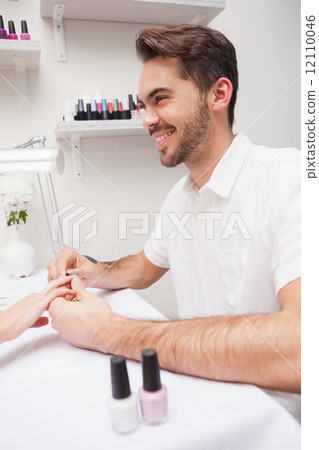 Manicurist giving customer a manicure Manicurist giving customer a manicure 12110046