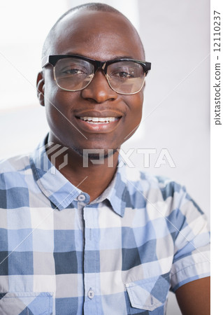 Portrait of a smiling businessman wearing glasses Portrait of a smiling businessman wearing glasses 12110237