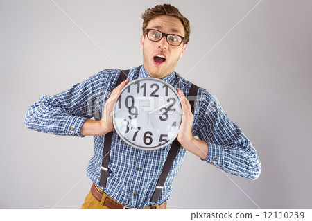 Geeky businessman holding a clock 12110239