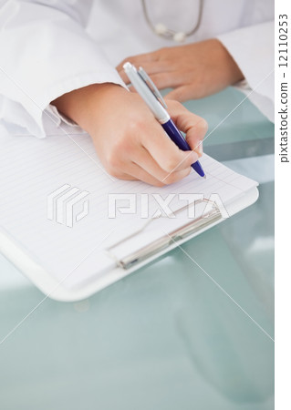 Doctor writing down work notes 12110253