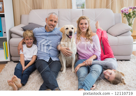 Parents and children on rug with labrador Parents and children on rug with labrador 12110719