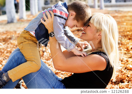 Little toddler boy in autumn park with his mother Little toddler boy in autumn park with his mother 12126288