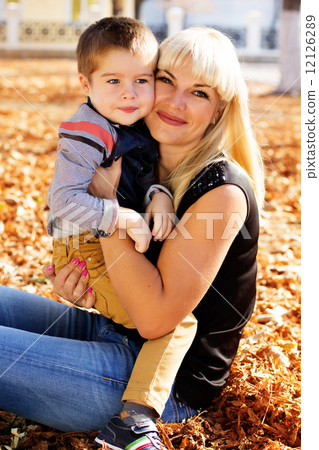 Little toddler boy in autumn park with his mother Little toddler boy in autumn park with his mother 12126289