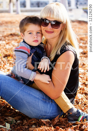 Little toddler boy in autumn park with his mother Little toddler boy in autumn park with his mother 12126290
