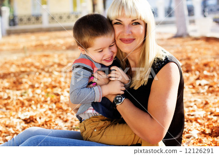 Little toddler boy in autumn park with his mother Little toddler boy in autumn park with his mother 12126291