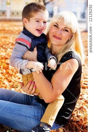 Little toddler boy in autumn park with his mother Little toddler boy in autumn park with his mother 12126292