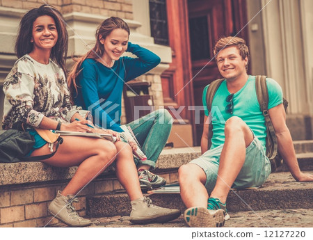 Group of multi ethnic students near university building entrance 12127220