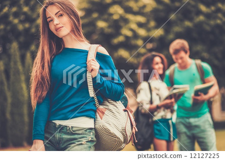 Beautiful young girl student in a city park on summer day Beautiful young girl student in a city park on summer day 12127225