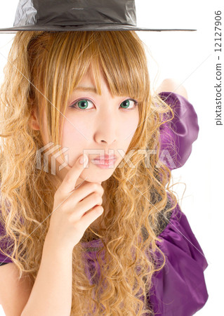 A cute girl who makes a witch's costume in Halloween A cute girl who makes a witch's costume in Halloween 12127906