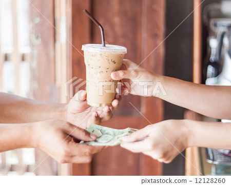 Giving money for freshly brewed coffee 12128260
