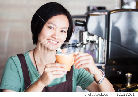 Asian barista enjoy her coffee 12128261