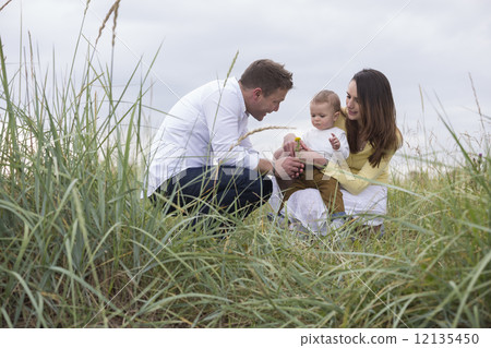 Young family In Sand Dunes. Young family In Sand Dunes. 12135450