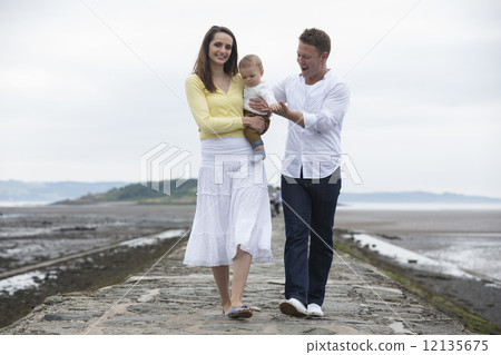 Young Family together on beach. Young Family together on beach. 12135675