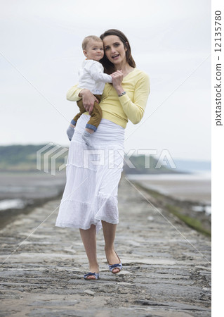 Mother and baby at the beach. 12135780