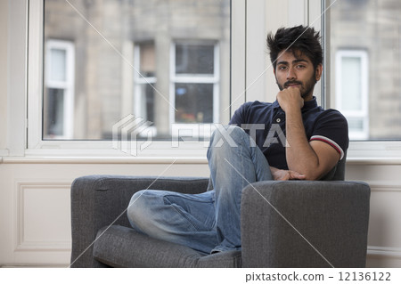 Portrait of a trendy Asian man at home. 12136122