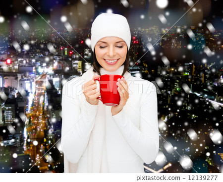 smiling young woman in winter clothes with cup smiling young woman in winter clothes with cup 12139277