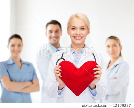 smiling female doctor with heart and stethoscope smiling female doctor with heart and stethoscope 12139287