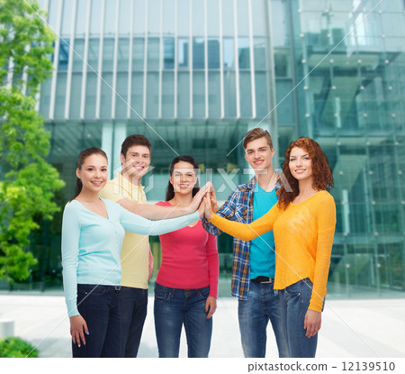 smiling teenagers making high five 12139510