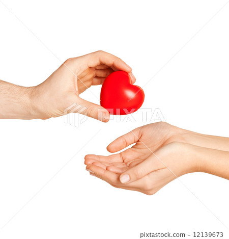 man hand giving red heart to woman man hand giving red heart to woman 12139673