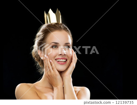 laughing woman wearing golden crown 12139735