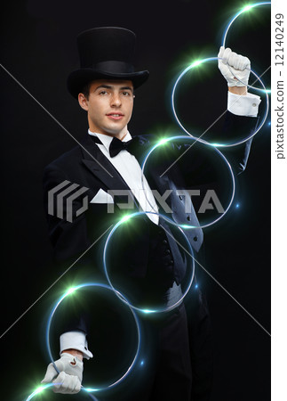 magician showing trick with linking rings 12140249