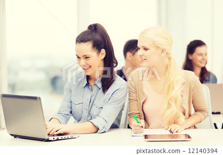 students with laptop, tablet pc and notebooks 12140394