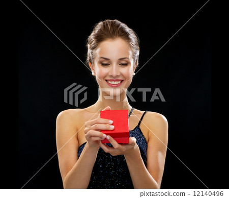 smiling woman holding red gift box smiling woman holding red gift box 12140496