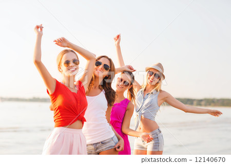 group of smiling women dancing on beach group of smiling women dancing on beach 12140670