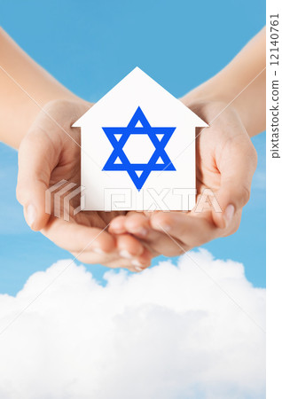 close up of hands holding house with star of david close up of hands holding house with star of david 12140761