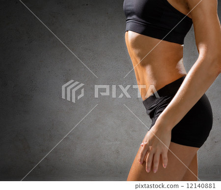 close up of athletic female abs in sportswear 12140881