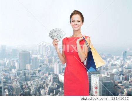 smiling woman in red dress with shopping bags smiling woman in red dress with shopping bags 12141652