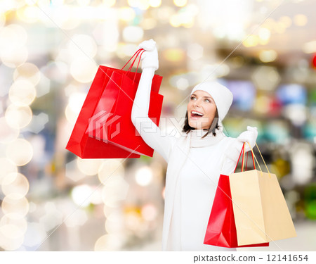 smiling young woman with red shopping bags smiling young woman with red shopping bags 12141654