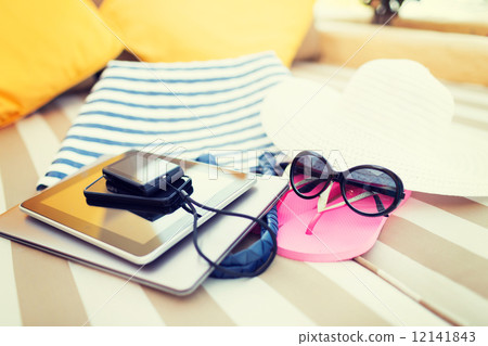 close up of tablet pc and smartphone on beach 12141843