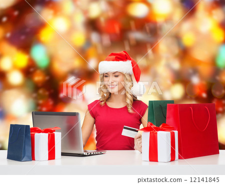smiling woman with credit card and laptop 12141845