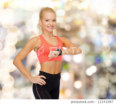 smiling woman with heart rate monitor on hand smiling woman with heart rate monitor on hand 12141997