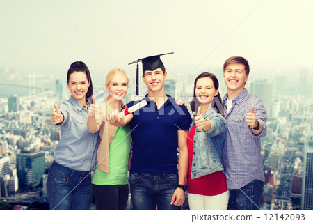 group of students with diploma showing thumbs up 12142093
