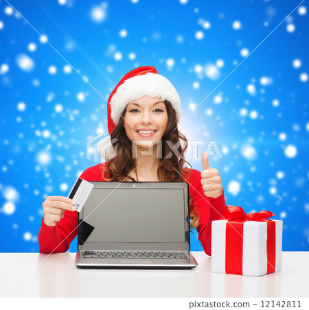 smiling woman with credit card and laptop 12142811