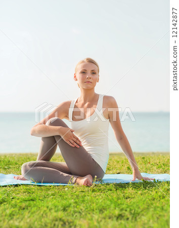 smiling woman making yoga exercises outdoors smiling woman making yoga exercises outdoors 12142877
