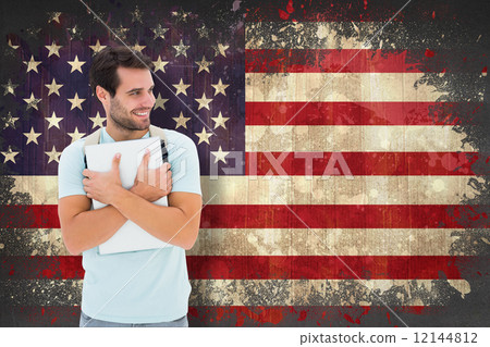 Composite image of student holding laptop 12144812