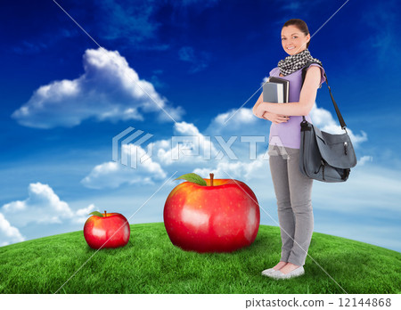 Composite image of attractive student holding books and her bag Composite image of attractive student holding books and her bag 12144868
