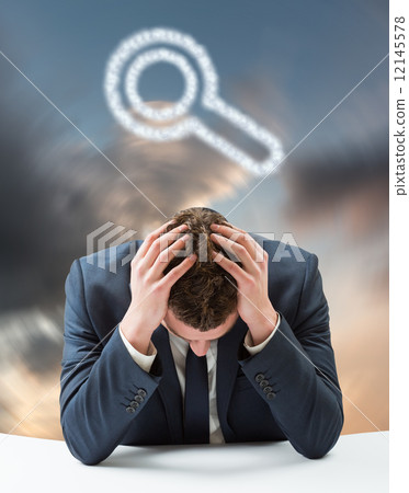 Composite image of businessman with head in hands 12145578