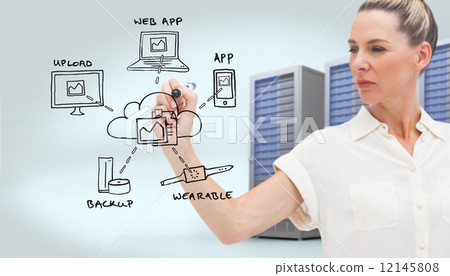 Composite image of serious businesswoman looking at pen in her h 12145808