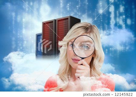 Composite image of fair-haired woman looking through a magnifyin 12145922