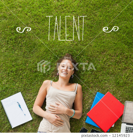 Talent against pretty student lying on grass 12145923