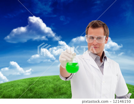 Composite image of young scientist working with a beaker 12146150