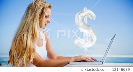Composite image of pretty blonde using her laptop at the beach 12146689