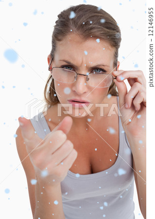 Composite image of portrait of a serious woman with glasses poin 12146955